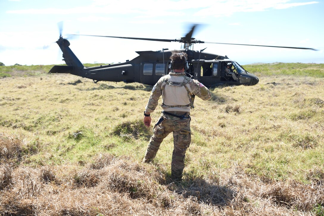 160710-F-DF491-288 POHAKULOA TRAINING AREA, Hawaii (July 9, 2016) -- A combat controller from the 320th Special Tactics Squadron clears a UH-60 Blackhawk for takeoff during a humanitarian assistance and disaster response as part of Rim of the Pacific 2016, at Pohakuloa Training Area, Hawaii, July 10, 2016. Twenty-six nations, more than 40 ships and submarines, more than 200 aircraft and 25,000 personnel are participating in RIMPAC from June 30 to Aug. 4, in and around the Hawaiian Islands and Southern California. The world's largest international maritime exercise, RIMPAC provides a unique training opportunity that helps participants foster and sustain the cooperative relationships that are critical to ensuring the safety of sea lanes and security on the world's oceans. RIMPAC 2016 is the 25th exercise in the series that began in 1971. (U.S. Air Force photo by 2nd Lt. Jaclyn Pienkowski)