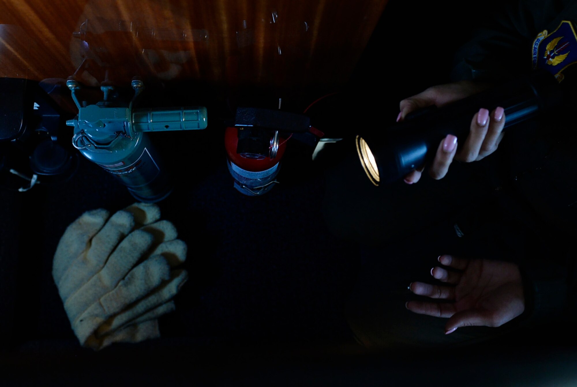 Staff Sgt. Ashleen Martinez, 76th Airlift Squadron flight attendant, reviews emergency gear before flight departure at Ramstein Air Base, Germany, July 12, 2016. Flight attendants are trained in emergency procedures for their respective aircrafts and ensure all equipment is serviceable prior to every flight. (U.S. Air Force photo/ Senior Airman Nesha Humes)