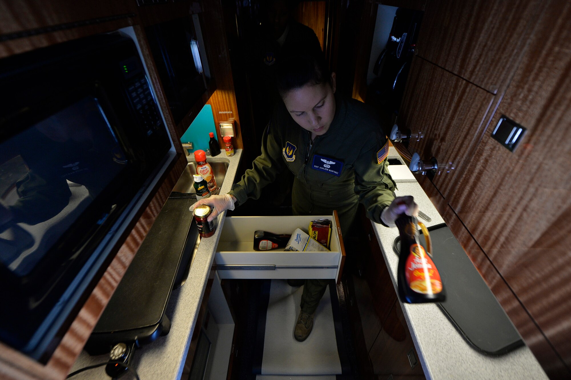 Staff Sgt. Ashleen Martinez, 76th Airlift Squadron flight attendant, prepares breakfast upon departing from Ramstein Air Base, Germany, July 12, 2016. In order to serve meals on time, attendants are taught time management and to utilize minimal space to plan, prep, cook and serve meals in an efficient time for distinguished visitors onboard. (U.S. Air Force photo/ Senior Airman Nesha Humes)