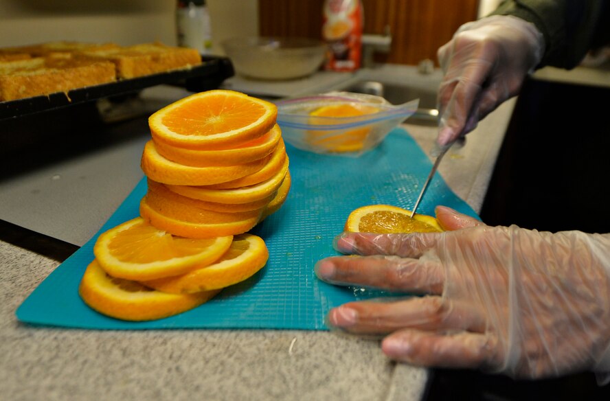 Staff Sgt. Ashleen Martinez, 76th Airlift Squadron flight attendant, prepares breakfast upon departing from Ramstein Air Base, Germany, July 12, 2016. Although safety is the primary mission onboard, attendants also plan, prep, cook, serve meals, clean and load baggage. (U.S. Air Force photo/ Senior Airman Nesha Humes)