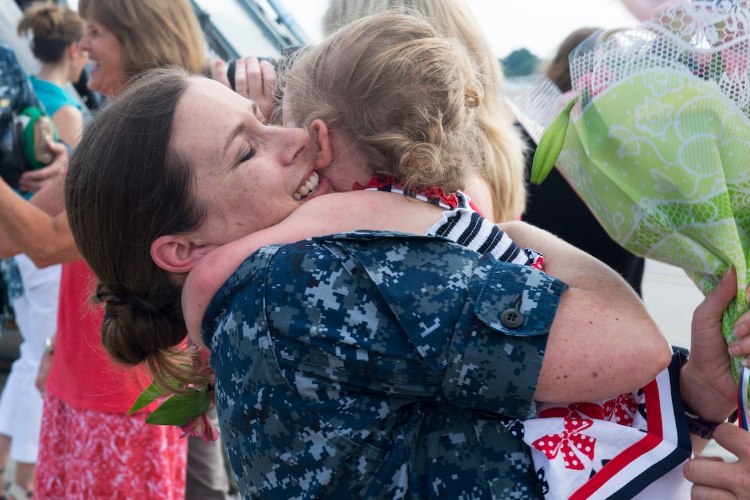 Navy Chief Melissa Insley reunites with her family during a homecoming celebration at Naval Station Norfolk in Virginia Beach, Va., July 13, 2016. The squadron returned after an eight-month deployment as part of the USS Harry S. Truman Carrier Strike Group in the 5th and 6th U.S. Fleet areas of responsibility in support of Operation Inherent Resolve. Insley is assigned to Helicopter Sea Combat Squadron 5. Navy by Petty Officer 3rd Class Tyler Preston