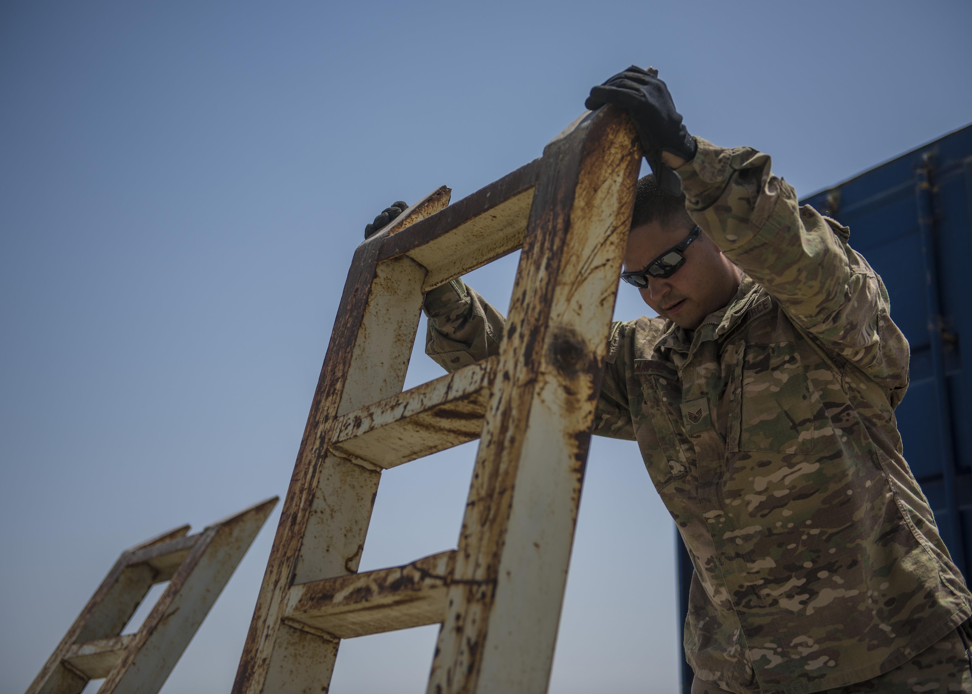 Staff Sgt. Jacob Chavez, 455th Expeditionary Logistics Readiness Squadron Central Command material recovery element, puts a vehicle ramp in place, July 14, 2016, Bagram Airfield, Afghanistan. The 455th ELRS CMRE team is tasked with conducting materiel reduction and engineer deconstruction operations in Afghanistan to procure valuable military equipment. (U.S. Air Force photo by Senior Airman Justyn M. Freeman)