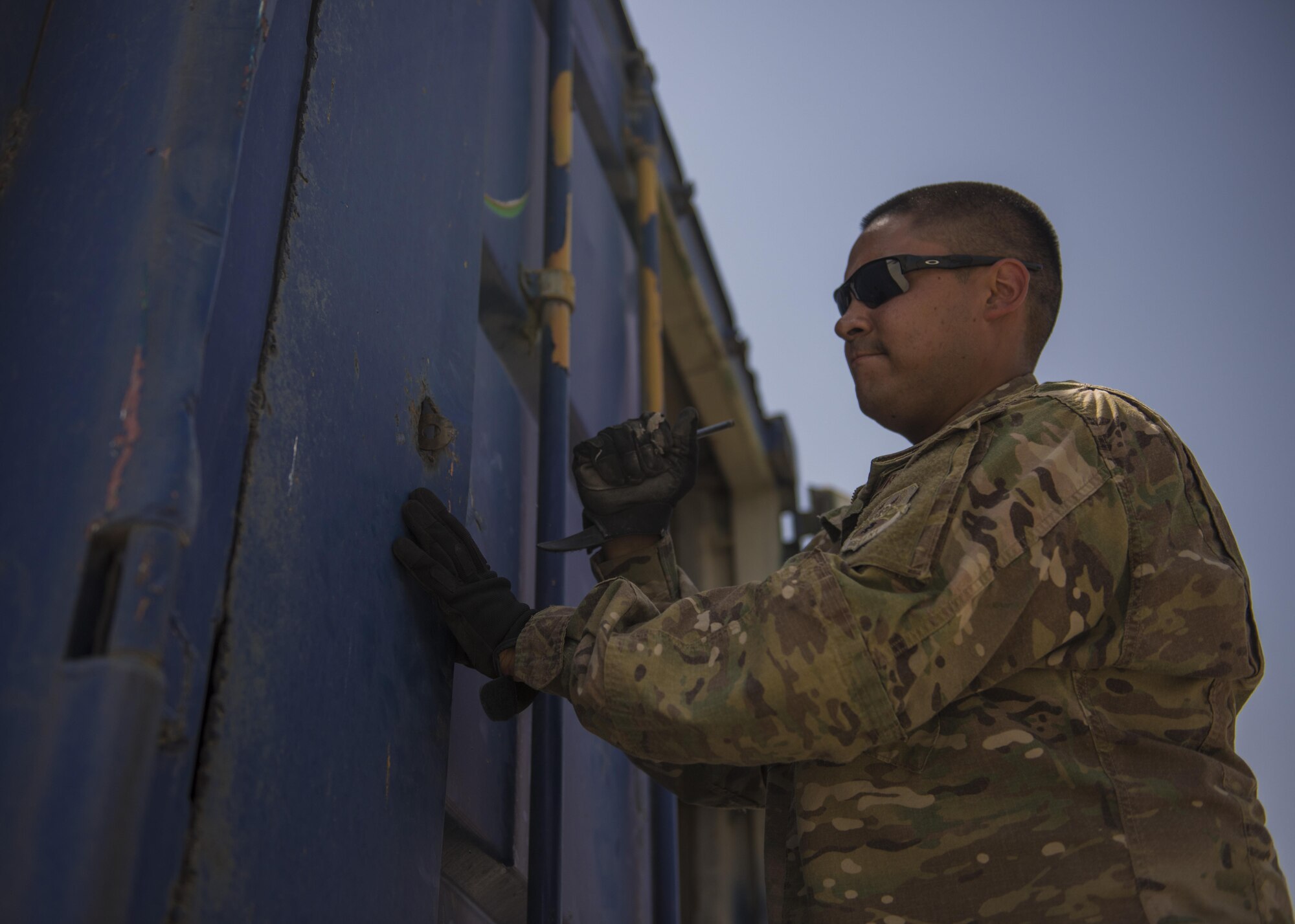 Staff Sgt. Jacob Chavez, 455th Expeditionary Logistics Readiness Squadron Central Command material recovery element, opens a truck container, July 14, 2016, Bagram Airfield, Afghanistan. The CMRE team accounts for and redeploys war reserve assets. (U.S. Air Force photo by Senior Airman Justyn M. Freeman)