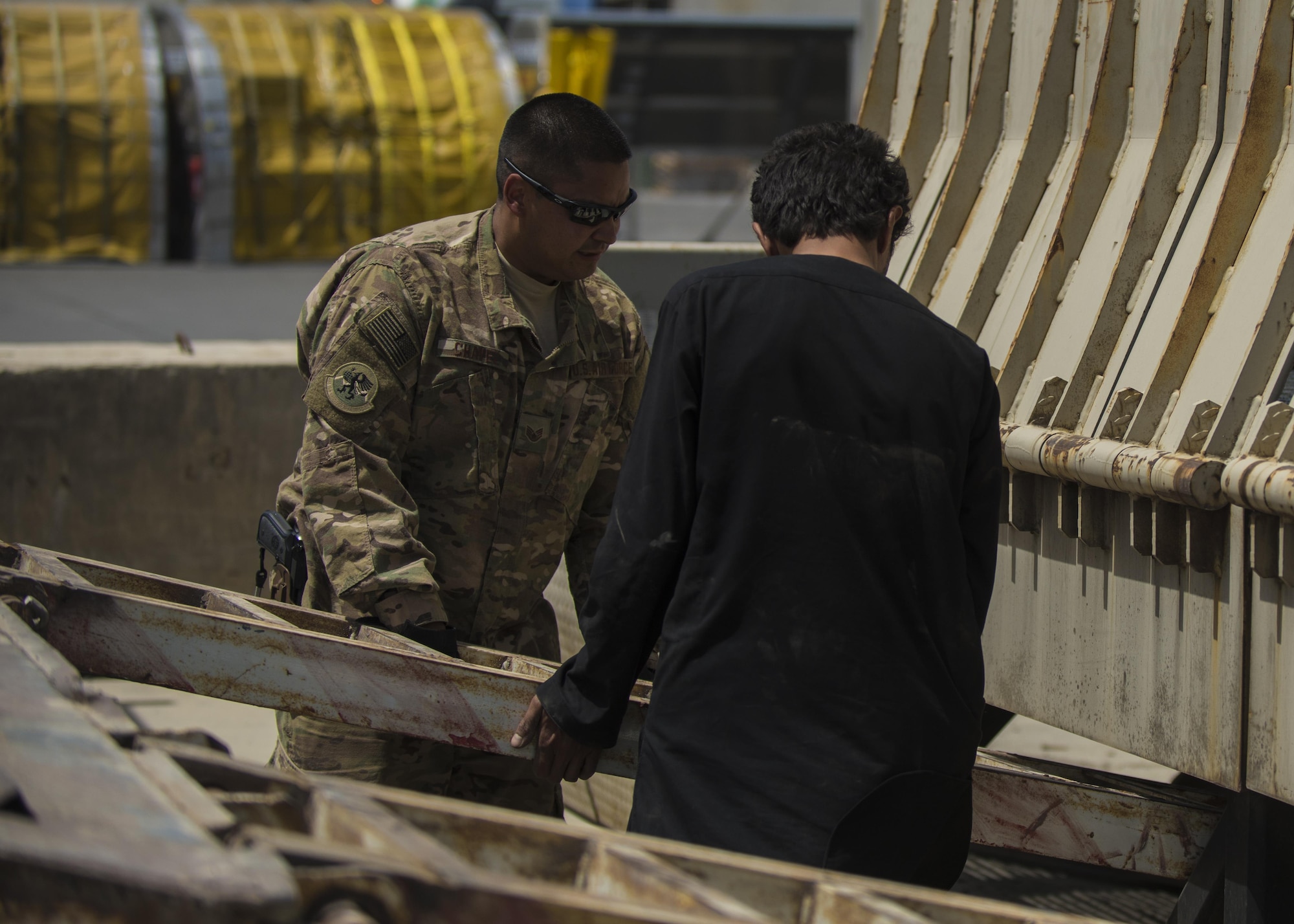 Staff Sgt. Jacob Chavez, 455th Expeditionary Logistics Readiness Squadron Central Command material recovery element, guides a vehicle ramp into place, July 14, 2016, Bagram Airfield, Afghanistan. The 455th ELRS CMRE team assesses and loads cargo, for future shipments. When dealing with retrograde HMMWVs, CMRE added a vehicle mechanic to their group to oversee the load. (U.S. Air Force photo by Senior Airman Justyn M. Freeman)