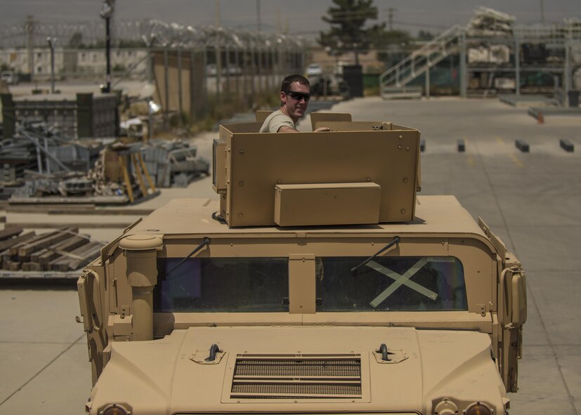 Staff Sgt. Mark Wolford, 455th Expeditionary Logistics Readiness Squadron Central Command material recovery element vehicle mechanic, sits in a high mobility multipurpose wheeled vehicle, July 14, 2016, Bagram Airfield, Afghanistan. The 455th ELRS CMRE team assesses and loads cargo, for future shipments. When dealing with retrograde HMMWVs, CMRE added a vehicle mechanic to their group to oversee the load. (U.S. Air Force photo by Senior Airman Justyn M. Freeman)