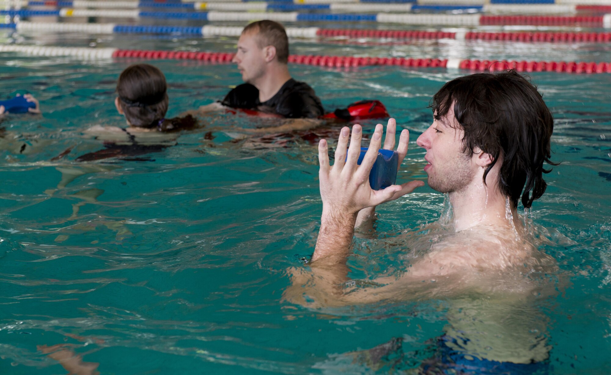 A student in the Ramstein Aquatic Center Lifeguard Course treads water for 15 seconds while holding a 10-pound weight July 14, 2016, at Ramstein Air Base, Germany. The students practiced treading water with a weight to get used to stabilizing a victim while in deep water. (U.S. Air Force photo/Airman 1st Class Tryphena Mayhugh)