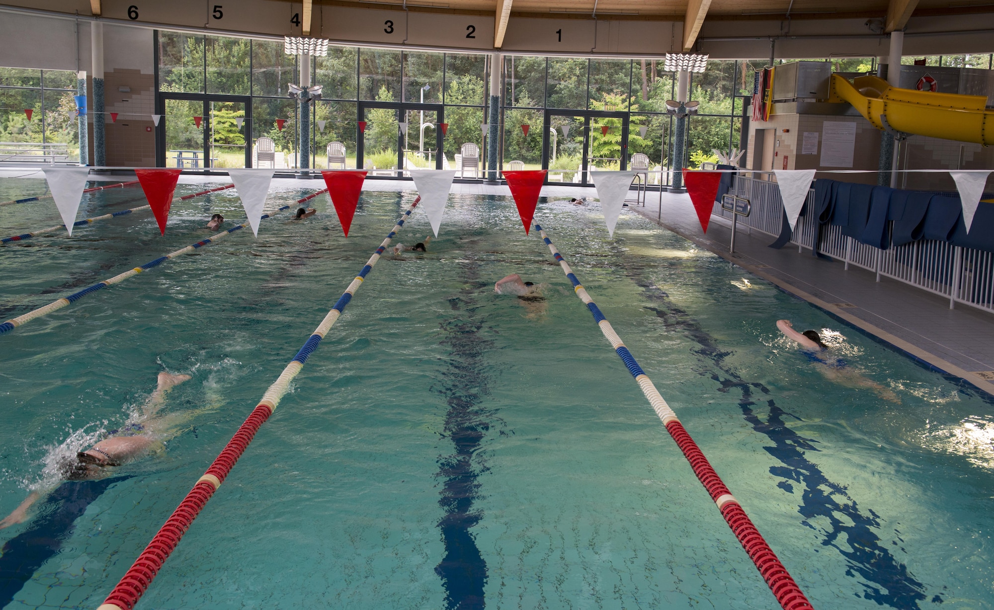 Students of the Ramstein Aquatic Center Lifeguard Course swim as a prerequisite to the course July 11, 2016, at Ramstein Air Base, Germany. The students had to be able to swim 300 meters, tread water without using their arms for two minutes and retrieve a 10-pound brick from the bottom of the pool in order to move on in the lifeguard course. (U.S. Air Force photo/Airman 1st Class Tryphena Mayhugh)