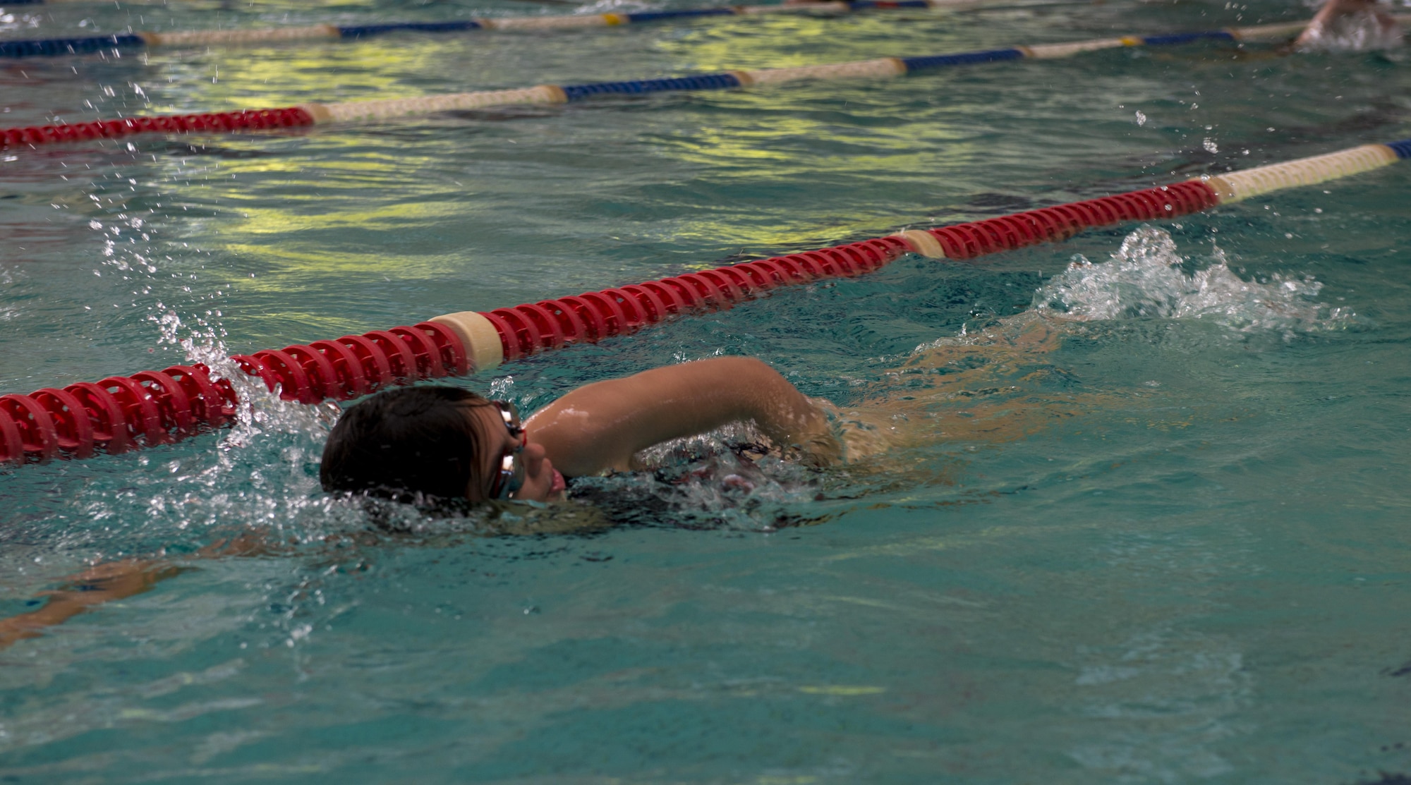 A student in the Ramstein Aquatic Center Lifeguard Course swims as a prerequisite for the course July 11, 2016, at Ramstein Air Base, Germany. The course provided training with CPR, first aid and a variety of rescue scenarios. (U.S. Air Force photo/Airman 1st Class Tryphena Mayhugh)