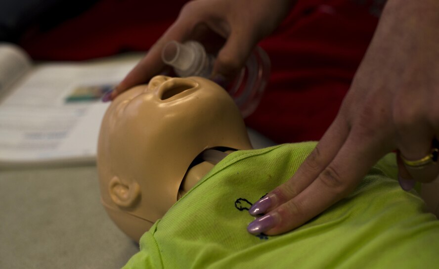 A student in the Ramstein Aquatic Center Lifeguard Course performs chest compressions on an infant dummy July 13, 2016, at Ramstein Air Base, Germany. The students were trained what to do if there’s a drowning versus non-drowning victim, if it’s an infant rather than an adult or the different roles depending on how many rescuers are responding. (U.S. Air Force photo/Airman 1st Class Tryphena Mayhugh)