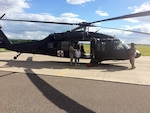 Crewmembers from the Wisconsin Army National Guard’s West Bend, Wis.-based Company F, 2nd Battalion, 238th Aviation assist a dialysis patient from the Bad River Reservation in northern Wisconsin out of a UH-60 Black Hawk helicopter July 13, 2016, after conducting a medevac mission from the reservation to Ashland, Wis., for treatment. Torrential rains and severe weather that struck the area July 11 cutoff road access to the reservation and left five members of the Bad River Band of Lake Superior Chippewa unable to get to a medical facility for dialysis.