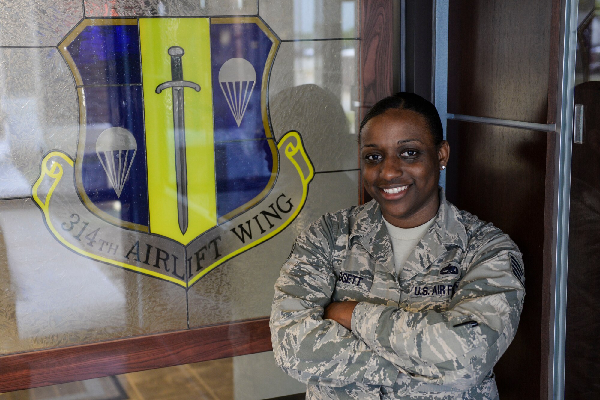 U.S. Air Force Col. James Dryjanksi, 314th Airlift Wing commander, left, congratulates U.S. Air Force Staff Sgt. Alescia Paggett, right, 314th Maintenance Group Plans and Scheduling NCO in charge, as the Combat Airlifter of the Week July 13, 2016, at Little Rock Air Force Base, Ark. Paggett created a daily, weekly and monthly maintenance schedule to ensure a 99.9 percent maintenance schedule effectiveness rate. (U.S. Air Force photo by Senior Airman Mercedes Taylor) 