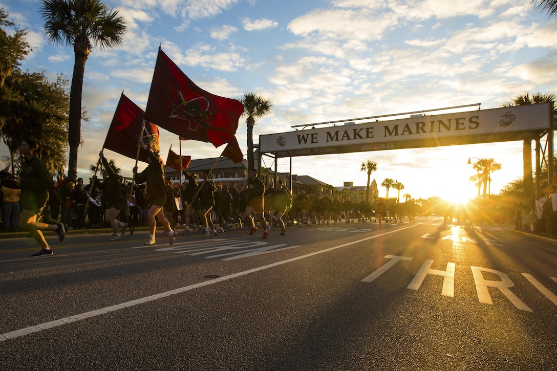 New Marines run under the iconic “We Make Marines” sign during a traditional motivational run through the streets of Parris Island, S.C.
