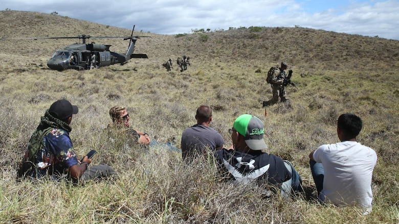 Marines wait for simulated aid during a humanitarian exercise at an improvised landing zone near the Pohakuloa Training Area, Hawaii, July 9, 2016, during Rim of the Pacific 2016. Twenty-six nations, 49 ships, six submarines, about 200 aircraft, and 25,000 personnel are participating in RIMPAC 2016 from June 29 to Aug. 4 in and around the Hawaiian Islands and Southern California. The world’s largest international maritime exercise, RIMPAC provides a unique training opportunity while fostering and sustaining cooperative relationships between participants critical to ensuring the safety of sea lanes and security on the world’s oceans. RIMPAC 16 is the 25th exercise in the series that began in 1971.