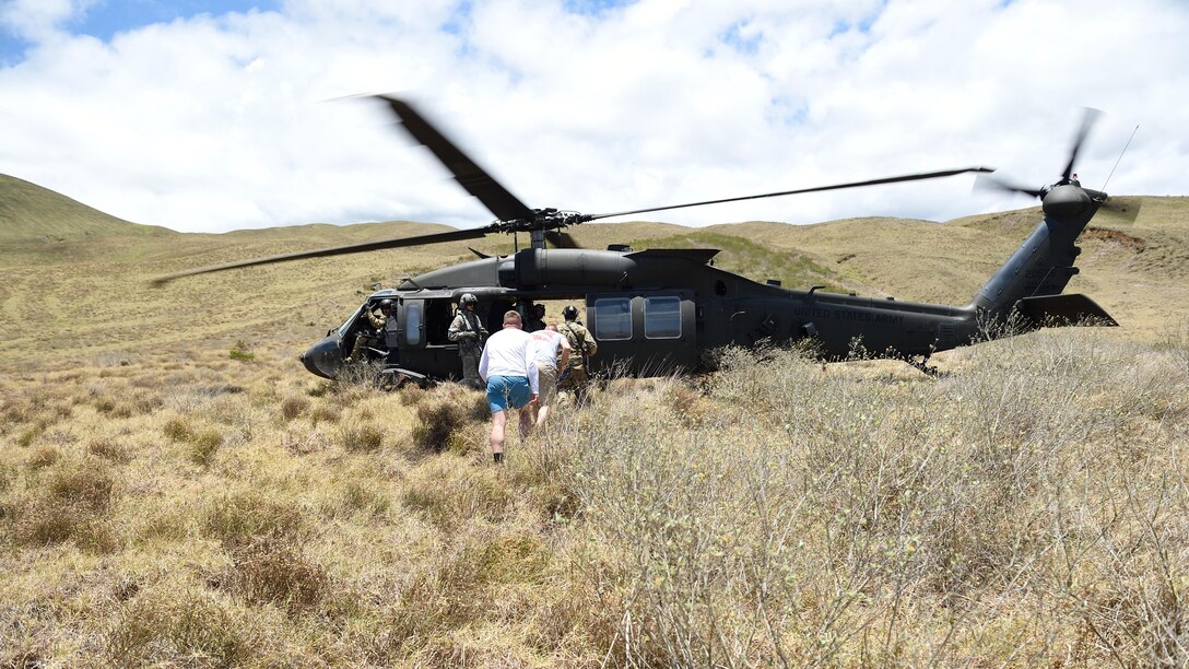 A pararescueman with the 320th Special Tactics Squadron escorts two simulated earthquake survivors to be evacuated from the area to safety in a UH-60 Blackhawk during a humanitarian assistance and disaster response scenario as part of Rim of the Pacific 2016, at Pohakuloa Training Area, Hawaii, July 10, 2016. RIMPAC offers the 320th Special Tactics and III Marine Expeditionary Force an opportunity to team up and practice their unique skills to strengthen their partnership in order to respond to crises quickly. Twenty-six nations, more than 40 ships and submarines, more than 200 aircraft and 25,000 personnel are participating in RIMPAC from June 30 to Aug. 4, in and around the Hawaiian Islands and Southern California. The world's largest international maritime exercise, RIMPAC provides a unique training opportunity that helps participants foster and sustain the cooperative relationships that are critical to ensuring the safety of sea lanes and security on the world's oceans. RIMPAC 2016 is the 25th exercise in the series that began in 1971.