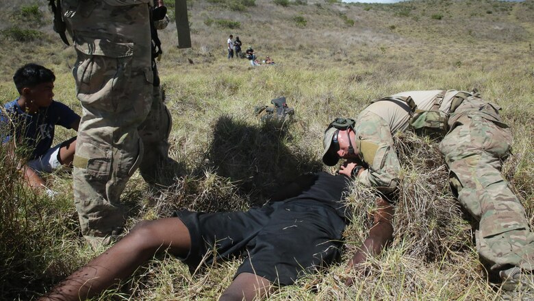 Air Force Pararescuemen with 320th Special Tactics Squadron, Air Force Special Operations Command render aid to a Marine at an improvised landing zone near the Pohakuloa Training Area, Hawaii, July 9, 2016, during a humanitarian aid and disaster relief exercise for Rim of the Pacific 2016. Twenty-six nations, 49 ships, six submarines, about 200 aircraft, and 25,000 personnel are participating in RIMPAC 16 from June 29 to Aug. 4 in and around the Hawaiian Islands and Southern California. The world’s largest international maritime exercise, RIMPAC provides a unique training opportunity while fostering and sustaining cooperative relationships between participants critical to ensuring the safety of sea lanes and security on the world’s oceans. RIMPAC 16 is the 25th exercise in the series that began in 1971.