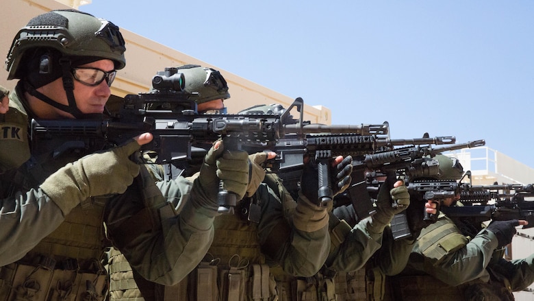 Deputy sheriffs with the San Bernardino County Sheriff’s Department Special Weapons and Tactics Team prepare to enter a building in the military operations in urban terrain facility at Range 800 aboard Marine Corps Air Ground Combat Center Twentynine Palms, Calif., July 12, 2016. The Combat Center’s Special Reaction Team hosted the cross-training to provide SBCSD with insight of the Marine Corps’ tactics capabilities. 