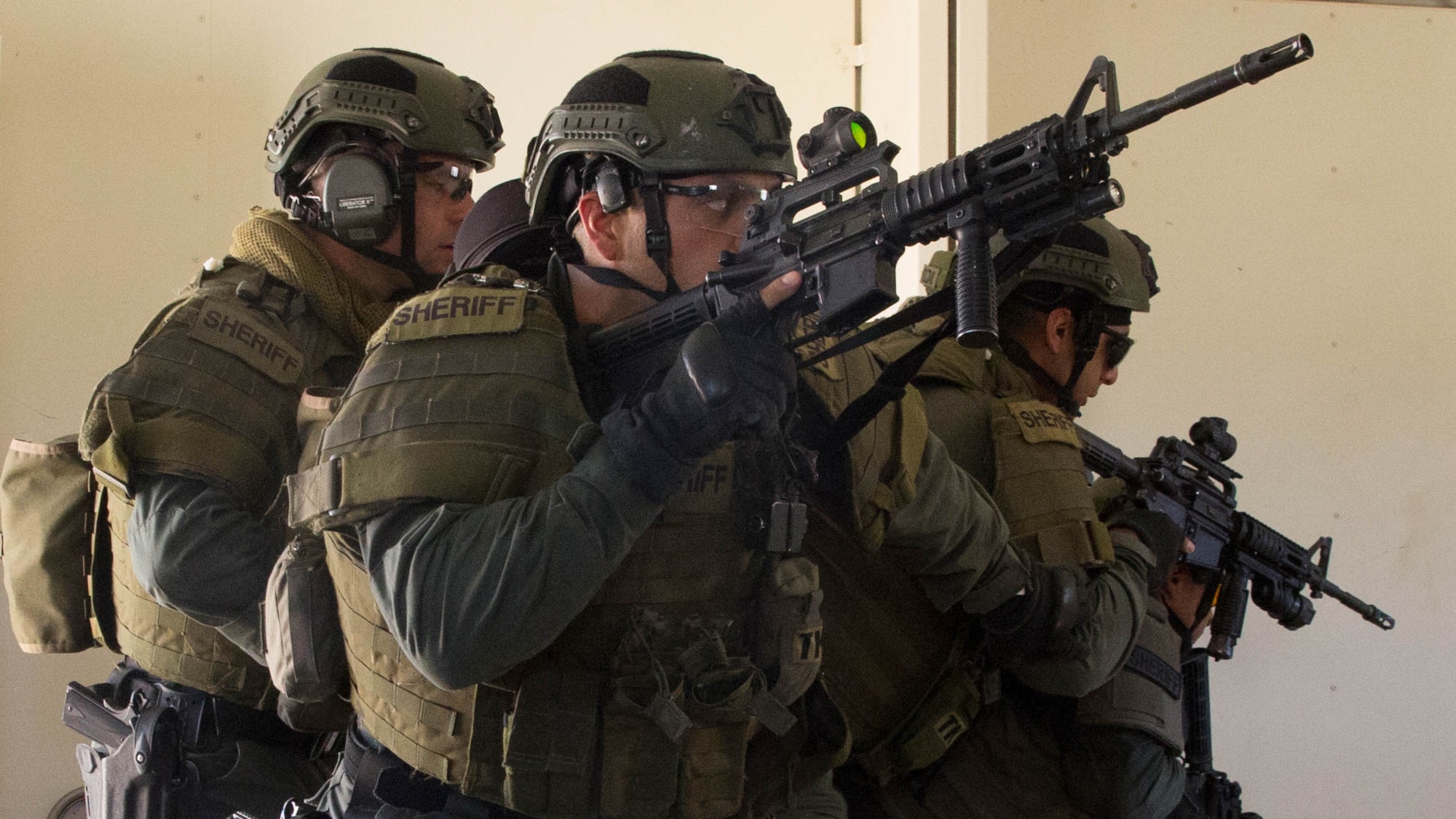 Deputy sheriffs with the San Bernardino County Sheriff’s Department Special Weapons and Tactics Team clear a building in the military operations in urban terrain facility at Range 800 at Marine Corps Air Ground Combat Center Twentynine Palms, Calif., July 12, 2016. The Combat Center’s Special Reaction Team hosted the cross-training to provide SBCSD with insight of the Marine Corps’ tactics capabilities. 