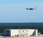 The 440th Airlift Wing's last remaining aircraft tilts its wing as it makes a final pass over the Pope Field hangar on its departure from Pope, June 29, 2016. The unit had been in the process of inactivation for several months and its other C-130s had been redistributed to other units. (Courtesy photo)