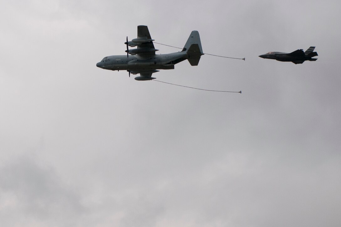 An F-35B Lightning II and a C-130J Super Hercules participate in an aerial demonstration at the Farnborough International Air Show, July 12, 2016. Held every two years, the air show represents a unique opportunity for the U.S., along with other military allies, to showcase its leadership in aerospace technologies while supporting various armament procurement competitions taking place throughout Europe. (U.S. Air Force photo by Master Sgt. Eric Burks/Released)