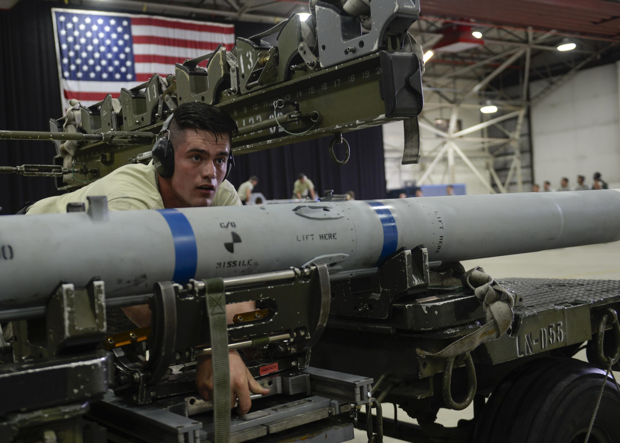 Staff Sgt. Zachary Restor, 48th Aircraft Maintenance Squadron weapons load crew member, loads a dummy missile onto an MJ-1 Lift Truck during a 48th Maintenance Group quarterly load crew competition at Royal Air Force Lakenheath, England, July 11. The load crew competition pitted Airmen from the 748th and 48th AMXS against each other to determine who will hold the title of best load crew of the quarter. (U.S. Air Force photo/Senior Airman Nigel Sandridge) 