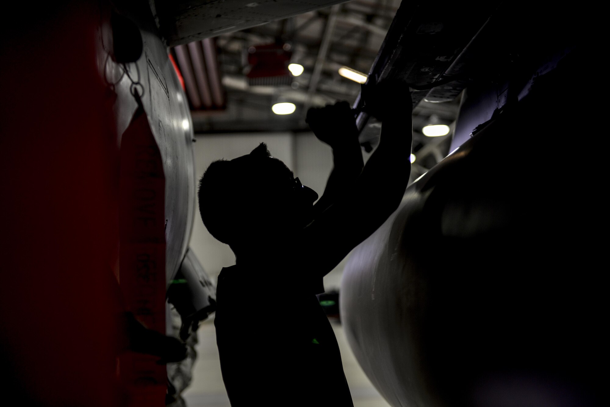 Senior Airman Ramsey Adair, 48th Aircraft Maintenance Squadron weapons load crew member, fastens a panel during a 48th Maintenance Group quarterly load crew competition at Royal Air Force Lakenheath, England, July 11. The four-part competition consisted of a written test, uniform inspection, a weapons load and an inspection of the composite toolkit. (U.S. Air Force photo/Senior Airman Nigel Sandridge)