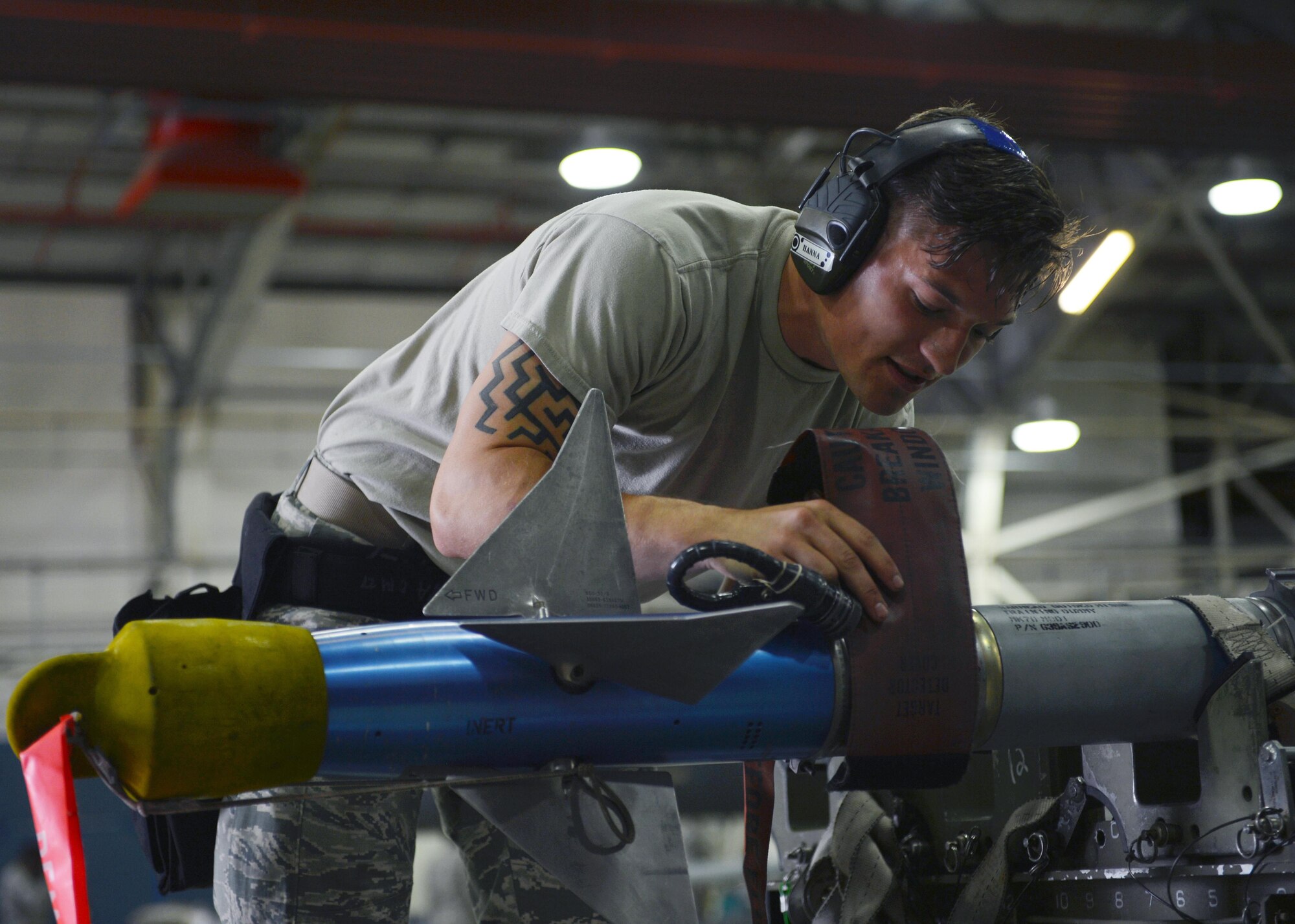 Airman 1st Class Taylor Hanna, 748th Aircraft Maintenance Squadron weapons load crew member, prepares to transfer a dummy missile to an F-15C Eagle at Royal Air Force Lakenheath, England, July 11. The 748th AMXS competed against the 48th AMXS for the load crew of the quarter trophy. (U.S. Air Force photo/Airman 1st Class Abby L. Finkel)