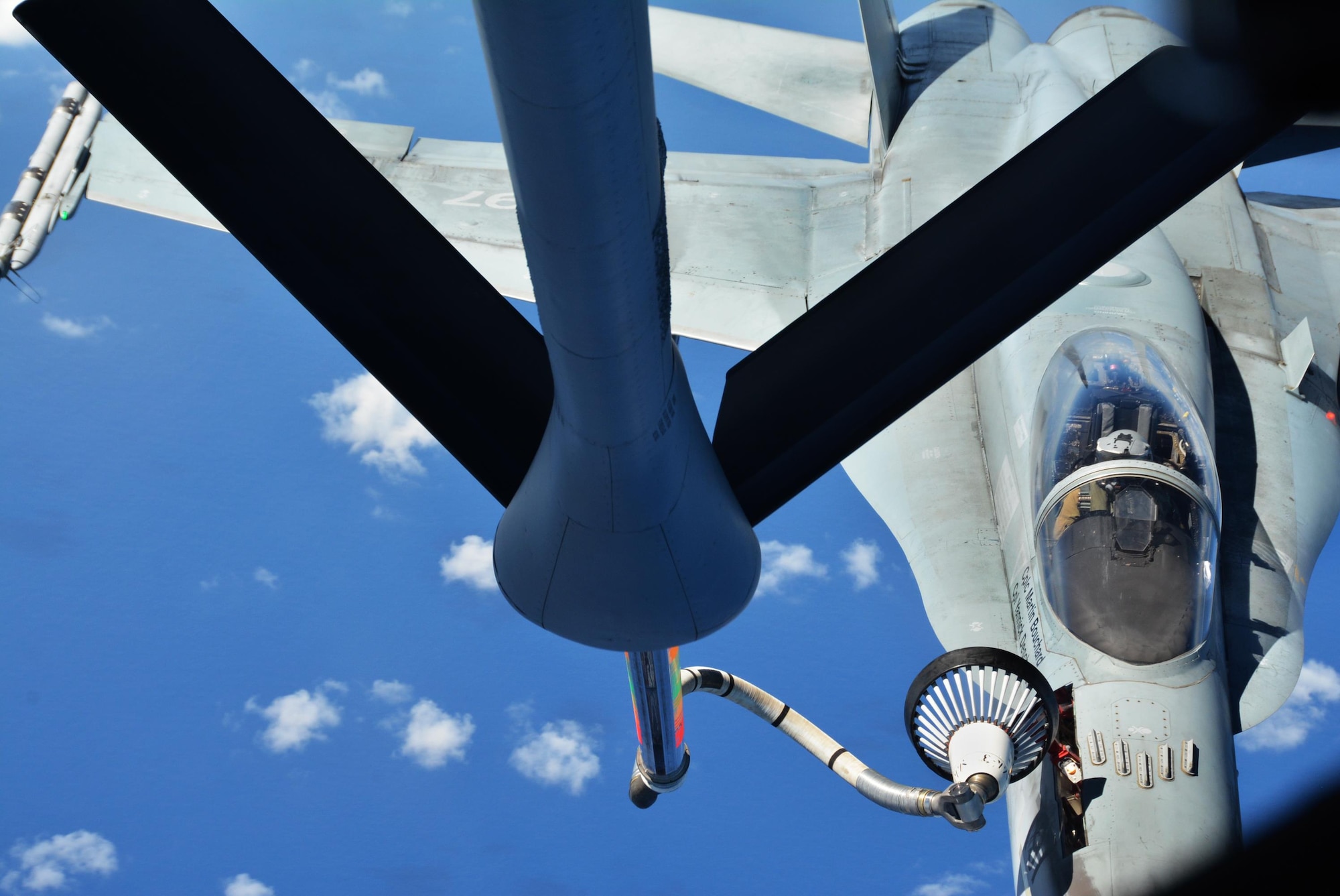 JOINT BASE PEARL HARBOR-HICKAM (July 11, 2016) A KC-135 crew from the 465th Air Refueling Squadron at Tinker Air Force Base, Okla., completes an aerial refueling of a Royal Canadian Air Force CF-18 Hornet July 11, 2016 in support of Rim of the Pacific 2016.  Twenty-six nations, more than 40 ships and submarines, more than 200 aircraft and 25,000 personnel are participating in RIMPAC from June 30 to Aug. 4, in and around the Hawaiian Islands and Southern California. The world's largest international maritime exercise, RIMPAC provides a unique training opportunity that helps participants foster and sustain the cooperative relationships that are critical to ensuring the safety of sea lanes and security on the world's oceans. RIMPAC 2016 is the 25th exercise in the series that began in 1971. (U.S. Air Force photo/Master Sgt. Grady Epperly)