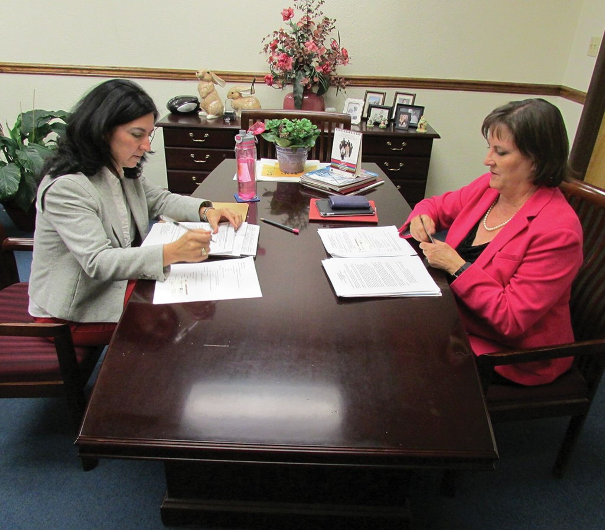 Cindy Dominguez-Trujillo, left, and Casey Anglada DeRaad, special assistants to the commander of the 377th Air Base Wing and executive director of the Air Force Nuclear Weapons Center, respectively, talk about increasing diversity on base in the office of Dominguez-Trujillo.
