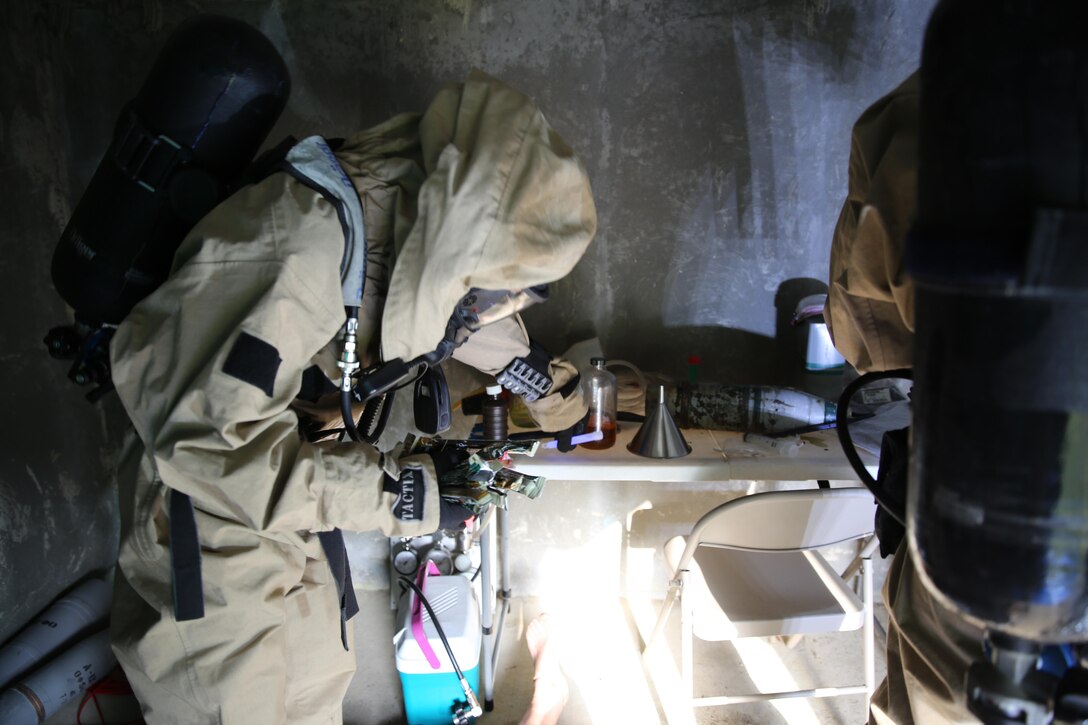 Lance Cpl. Ryan Shriver places chemical lights around a simulated incident site during a training exercise at Marine Corps Air Station Cherry Point, N.C., July 12, 2016. The training further refined the interoperability between MCAS Cherry Point’s Explosive Ordnance Disposal and 2nd Marine Aircraft Wing’s Chemical, Biological, Radiological and Nuclear Defense. Shriver is a CBRN defense specialist with Marine Wing Headquarters Squadron 2. (U.S. Marine Corps photo by Lance Cpl. Mackenzie Gibson/Released)