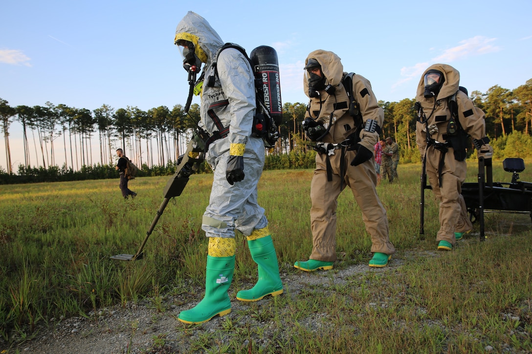 Marines with Marine Corps Air Station Cherry Point’s Explosive Ordnance Disposal and 2nd Marine Aircraft Wing’s Chemical, Biological, Radiological and Nuclear Defense sweep the area around a simulated incident site during a training exercise at MCAS Cherry Point, N.C., July 12, 2016. The purpose of the training was to further refine the interoperability between EOD and CBRN. (U.S. Marine Corps photo by Lance Cpl. Mackenzie Gibson/Released)
