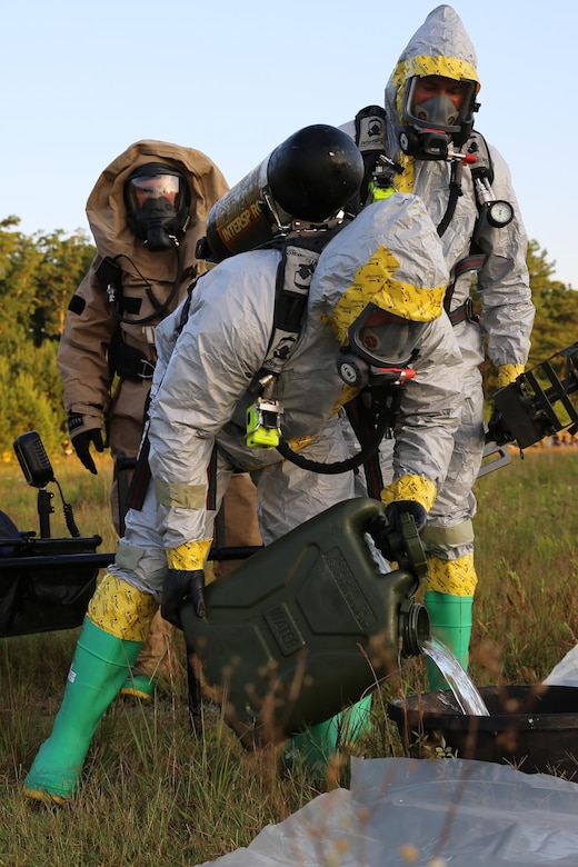 A Marine with Marine Corps Air Station Cherry Point Explosive Ordnance Disposal sets up his equipment outside of a simulated incident site during a training exercise at MCAS Cherry Point, N.C., July 12, 2016. The training further refined the interoperability between EOD and 2nd Marine Aircraft Wing’s Chemical, Biological, Radiological and Nuclear Defense. (U.S. Marine Corps photo by Lance Cpl. Mackenzie Gibson/Released)