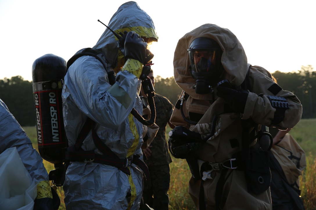 Marines with Marine Corps Air Station Cherry Point’s Explosive Ordnance Disposal and 2nd Marine Aircraft Wing’s Chemical, Biological, Radiological and Nuclear Defense conduct radio checks during a training exercise at MCAS Cherry Point, N.C., July 12, 2016. The training further refined the interoperability between EOD and CBRN. (U.S. Marine Corps photo by Lance Cpl. Mackenzie Gibson/Released)
