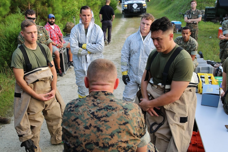 Marines with Marine Corps Air Station Cherry Point’s Explosive Ordnance Disposal and 2nd Marine Aircraft Wing’s Chemical, Biological, Radiological and Nuclear Defense receive a brief during a training exercise at MCAS Cherry Point, N.C., July 12, 2016. The training further refined the interoperability between EOD and CBRN. (U.S. Marine Corps photo by Lance Cpl. Mackenzie Gibson/Released)