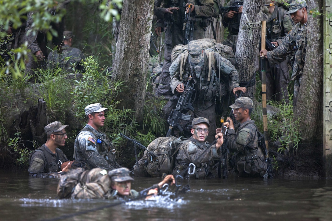 Soldiers cross a river using a single-line rope bridge during training at Camp Rudder at Eglin Air Force Base, Fla., July 7, 2016. Army photo by Sgt. Austin Berner