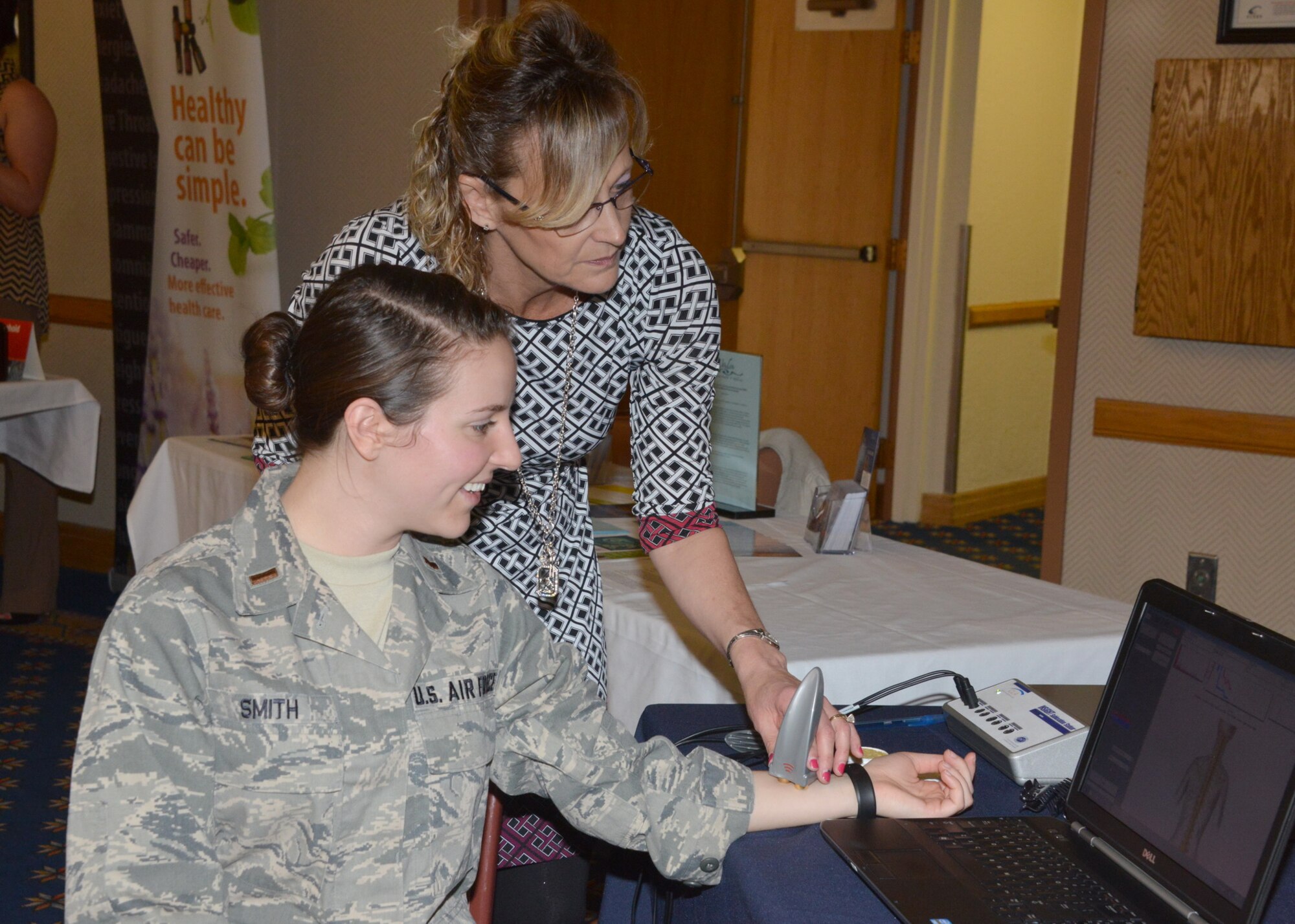A lieutenant gets here blood pressure checked at last year's Wellness Expo.  This year's Wellness Expo is set for 10 a.m. to 3 p.m. July 28 in the 150th Special Operations Wing main hangar, Building 1043, on Randolph Avenue. It includes about 70 vendors representing on- and off-base health entities and assistance agencies. (Photo by Dennis Carlson)