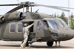 An Army National Guard Helicopter Taskforce Blackhawk crew chief helps secure his UH-60L at Illesheim airfield July 11. The task force is comprised of four UH-60L Black Hawks and Soldiers from the Colorado, Utah and Kansas Army National Guard and will be supporting Special Operations Command - Europe’s components during training and exercises throughout Europe for the next few months.