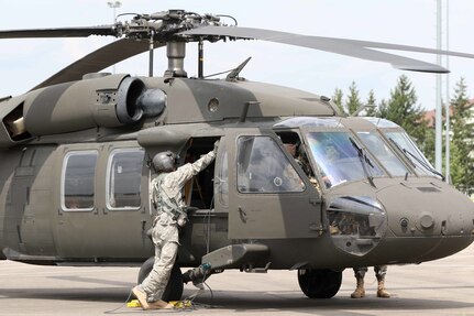 An Army National Guard Helicopter Taskforce Blackhawk crew chief helps secure his UH-60L at Illesheim airfield July 11. The task force is comprised of four UH-60L Black Hawks and Soldiers from the Colorado, Utah and Kansas Army National Guard and will be supporting Special Operations Command - Europe’s components during training and exercises throughout Europe for the next few months.