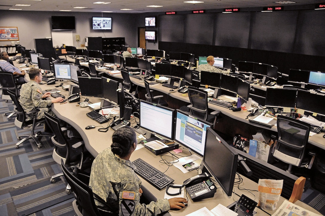 Uniformed and civilian cyber and military intelligence specialists monitor Army networks in the Cyber Mission Unit’s Cyber Operations Center at Fort Gordon, Ga. Courtesy photo by Michael L. Lewis