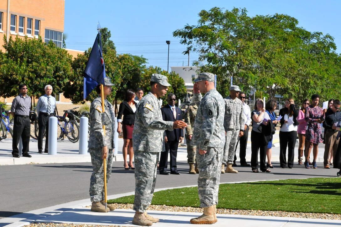 Sgt. 1st Class Francisco Matos (center), acting first sergeant, Headquarters and Headquarters Company, 63rd Regional Support Command, prepares to salute Lt. Col. Michael Stewart (left), company commander, HHC, 63rd RSC, following the conclusion of a change of command ceremony, July 13, Armed Forces Reserve Center, Mountain View, Calif. Stewart assumed command from outgoing commander Maj. Derrick Carter, who is departing to take a position with the 79th Sustainment Command.