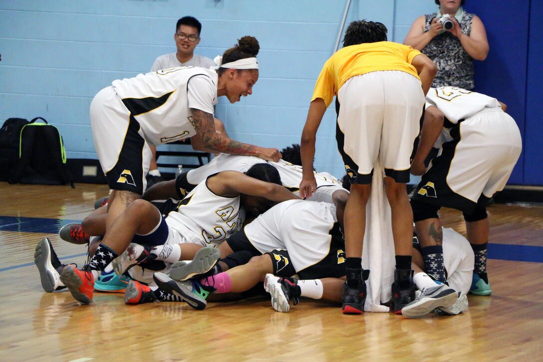 Army players celebrate immediately after Spc. Vanessa Laminson's last second basket during the championship game of the 2016 Armed Forces Women's Basketball Championship at Joint Base San Antonio-Lackland AFB, Texas on July 7th. Laminson would score the winning basket as time expired immediately after the ball left her hands. Army defeats Navy 67-65