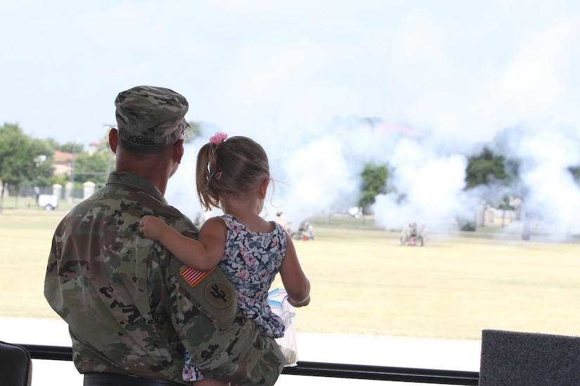 JBSA FORT SAM HOUSTON- Major General Jones and granddaughter look as the cannons fire at the conclusion of the ceremony at the MacArthur Parade Field. The firing of the cannons symbolizes the generals “Texas farewell”, said Command Sergeant Major Paul Swanson.
(Photo by Spc. Eddie Serra of the 205th Press Camp Headquarters)