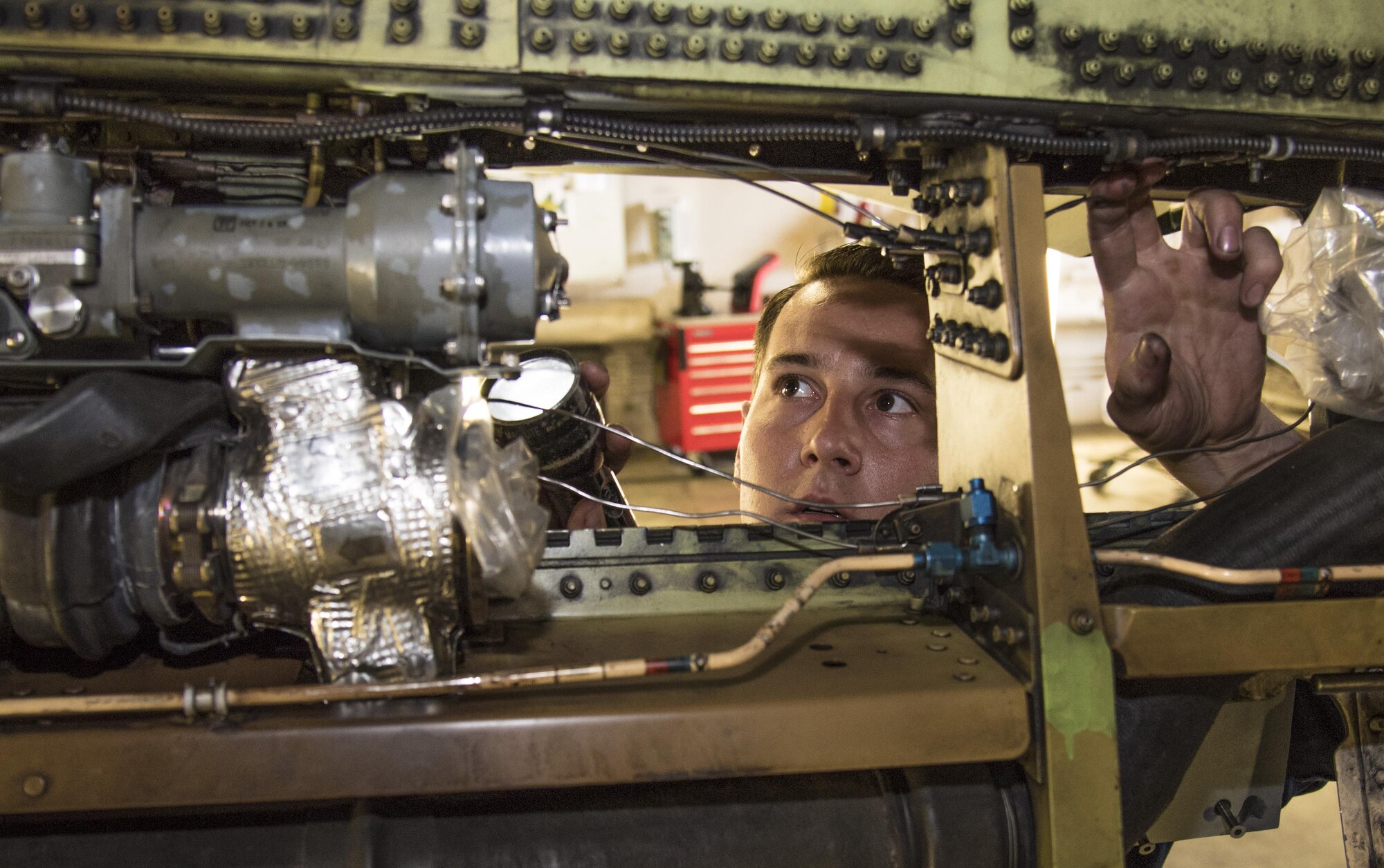 Staff Sgt. Beau Blackburn, a dedicated crew chief with the 35th Aircraft Maintenance Squadron, shines a flashlight into an F-16 Fighting Falcon at Misawa Air Base, Japan, June 16, 2016. Visibility is a necessary aspect of inspections when maintenance Airmen search throughout an aircraft for parts or damage. (U.S. Air Force photo/Airman 1st Class Jordyn Fetter)