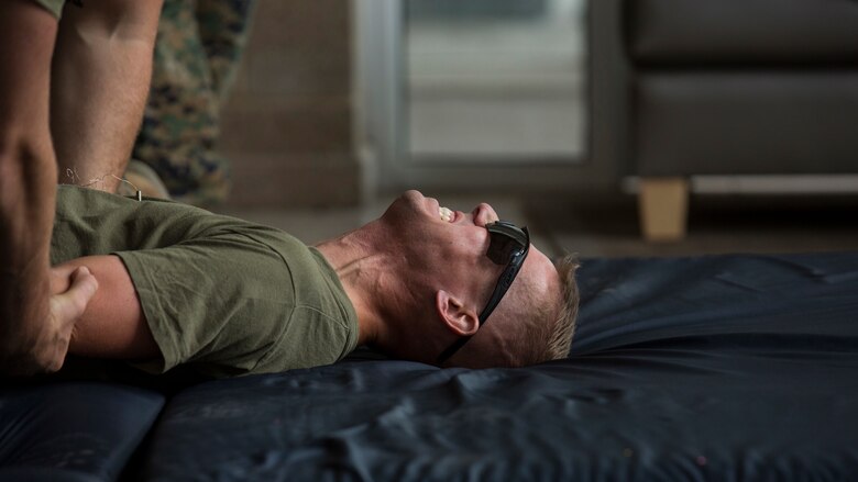 Capt. Keith Toucey, company commander for 3rd Battalion, 2nd Marine Regiment, Kilo Company, feels over 1,000 volts flowing through his body from a taser during a non-lethal weapons course at Marine Corps Base Camp Lejeune, North Carolina, July 15, 2016. Throughout the course they learned about various take-down techniques utilizing a police baton, riot control formations and tactics as well as the function and result of using a taser. 