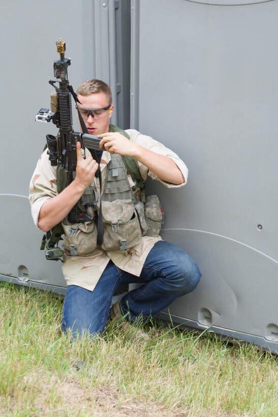 U.S. Army Pvt. Chad Turlington, 222nd Battalion, 1st Brigade Combat Team, 10th Mountain Division, reloads his M4 carbine while acting as a notional opposing force (OPFOR) during Warrior Exercise (WAREX) 86-16-03 at Fort McCoy, Wis., July 14, 2016. WAREX is designed to keep soldiers all across the United States ready to deploy. (U.S. Army photo by Spc. Cody Hein/Released)