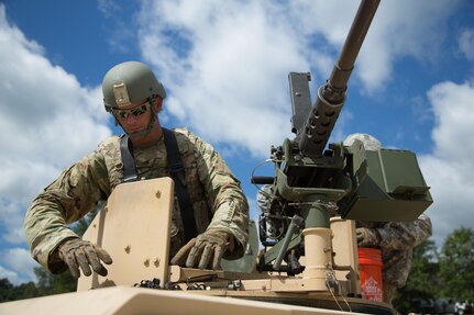 U.S. Army Sgt. Tommy Evans, 368 Financial Management Support Unit, cleans spent shell casings from an M2 Browning, .50 Caliber Machine Gun on a High Mobility Multipurpose Wheeled Vehicles (HMMWV) at a live fire exercise during Warrior Exercise (WAREX) 86-16-03 at Fort McCoy, Wis., July 14, 2016. WAREX is designed to keep soldiers all across the United States ready to deploy. (U.S. Army photo by Spc. John Russell/Released)