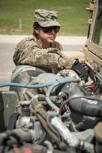 U.S. Army Spc. Gabriella Soto, 368 Financial Management Support Unit, cleans spent shell casings from an M2 Browning, .50 Caliber Machine Gun on a High Mobility Multipurpose Wheeled Vehicles (HMMWV) at a live fire exercise during Warrior Exercise (WAREX) 86-16-03 at Fort McCoy, Wis., July 14, 2016. WAREX is designed to keep soldiers all across the United States ready to deploy. (U.S. Army photo by Spc. John Russell/Released)