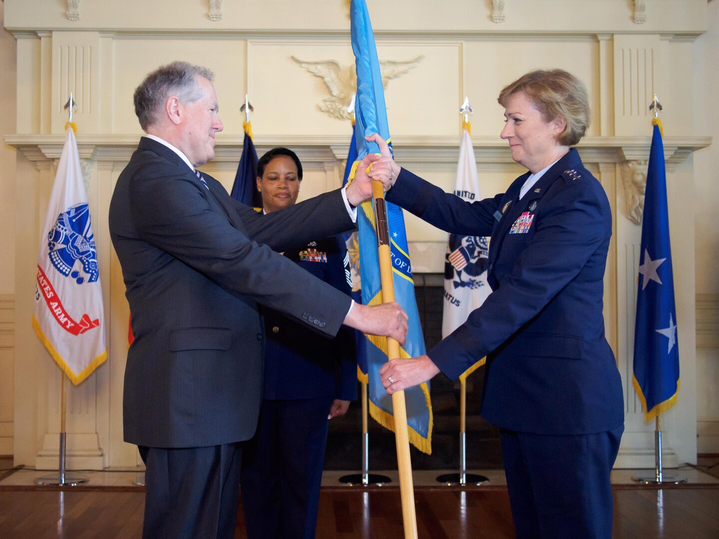 Air Force Lt. Gen. Wendy Masiello, incoming Defense Contract Management Agency director, accepts the agency's flag from Under Secretary of Defense for Acquisition, Technology and Logistics Frank Kendall during a change of leadership ceremony on Fort Lee, Va., today. 