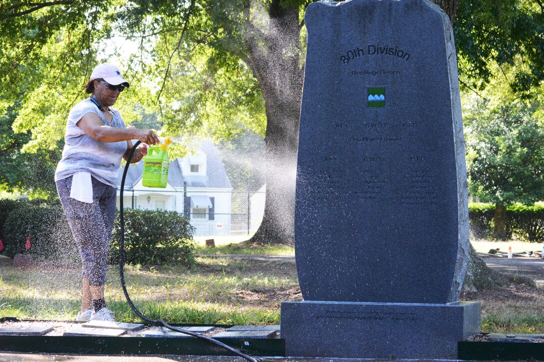 Sgt. Maj. Wanda Rich-Morrison, assigned to the 80th Training Command headquarters, cleans a monument on the headquarters grounds in Richmond, Va., July 14, 2016. Realizing that the contractors responsible for maintaining the grounds of the 80th Training Command headquarters were only responsible for cutting the grass, Soldiers and civilians assigned to the headquarters, decided to do something about it.  
They fought insects in 90 degree plus temperature for three days cleaning up debris and unsightly weeds around the building. 
“The Soldiers and civilians got back to the basics of policing their area,” said Michael Bland, the 80th TC’s chief executive officer. “In the current military environment, we have come to rely too much on contractors to handle that type of work.”