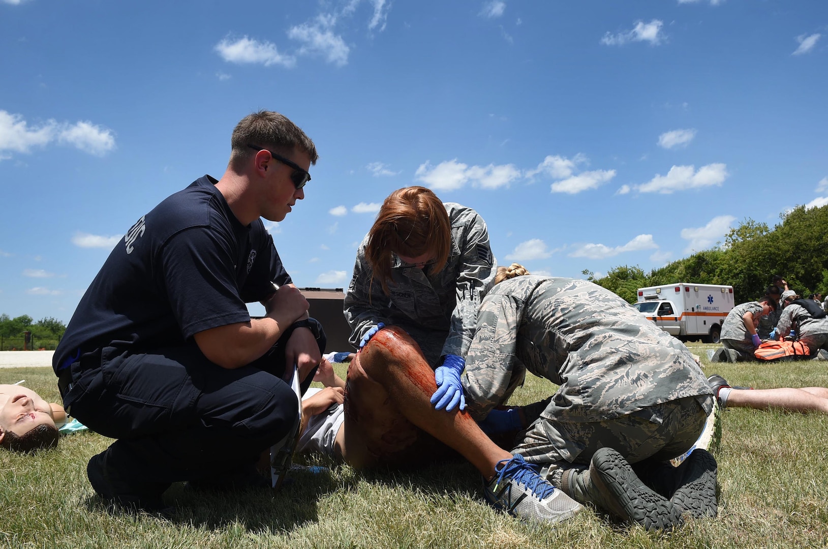 Senior Airman Lucas Reaume, a paramedic from the 59th Emergency Medical Services team, observes medics from the 59th MDW as they triage a patient during a July 13, 2016 disaster response exercise at Camp Bramble on Joint Base San Antonio-Lackland, Texas. The paramedics served as evaluators during the exercise, which simulated an aircraft crash. Evaluators were tasked to assess the response, and identify best practices and areas for improvement to ensure that 59th MDW warrior medics remain mission ready and capable. (U.S. Air Force photo/Staff Sgt. Jerilyn Quintanilla)