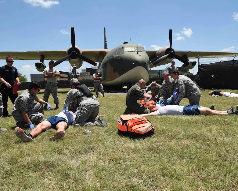 Medics from of the 59th Medical Wing tend to patients with simulated injuries during a July 13, 2016 disaster response exercise on Joint Base San Antonio-Lackland, Texas. More than 50 Airmen participated in the exercise, which simulated an aircraft crash designed to test the team’s ability to respond and treat patients in the event of a real-world incident. (U.S. Air Force photo/Staff Sgt. Jerilyn Quintanilla)